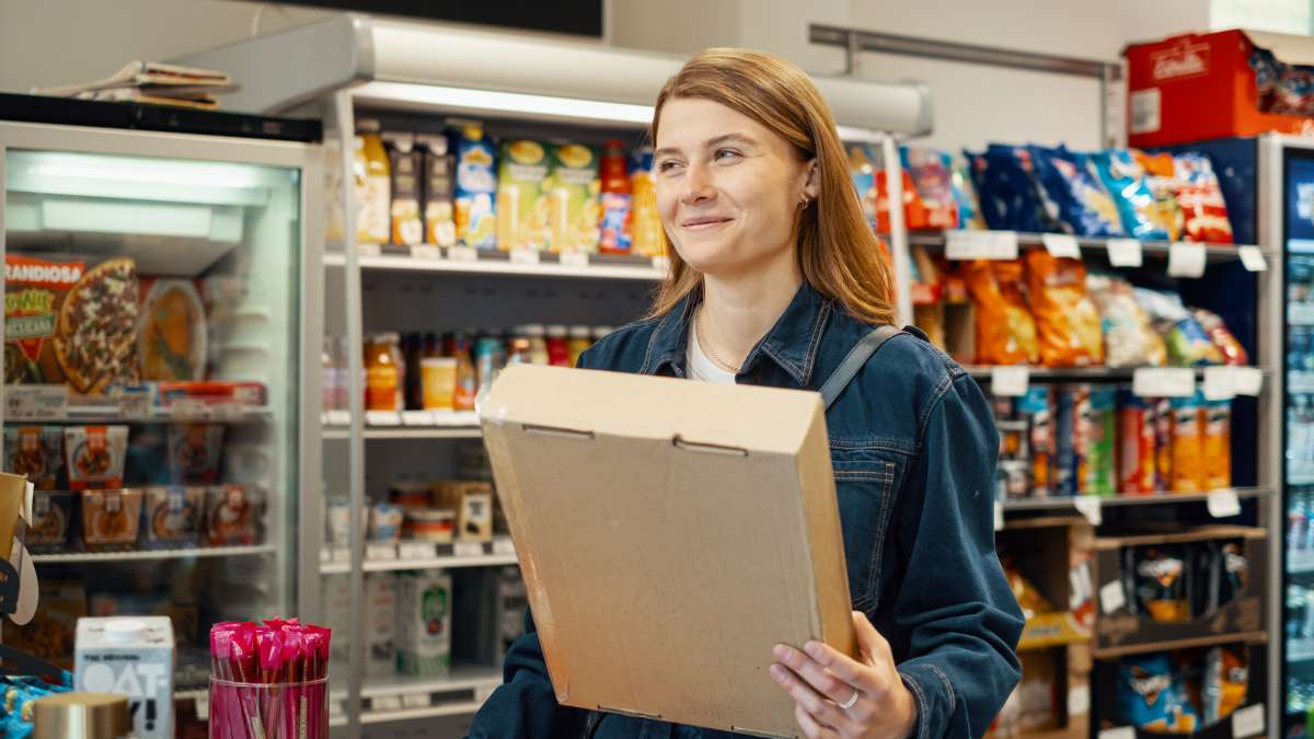 A woman collecting her parcel at a pick up point