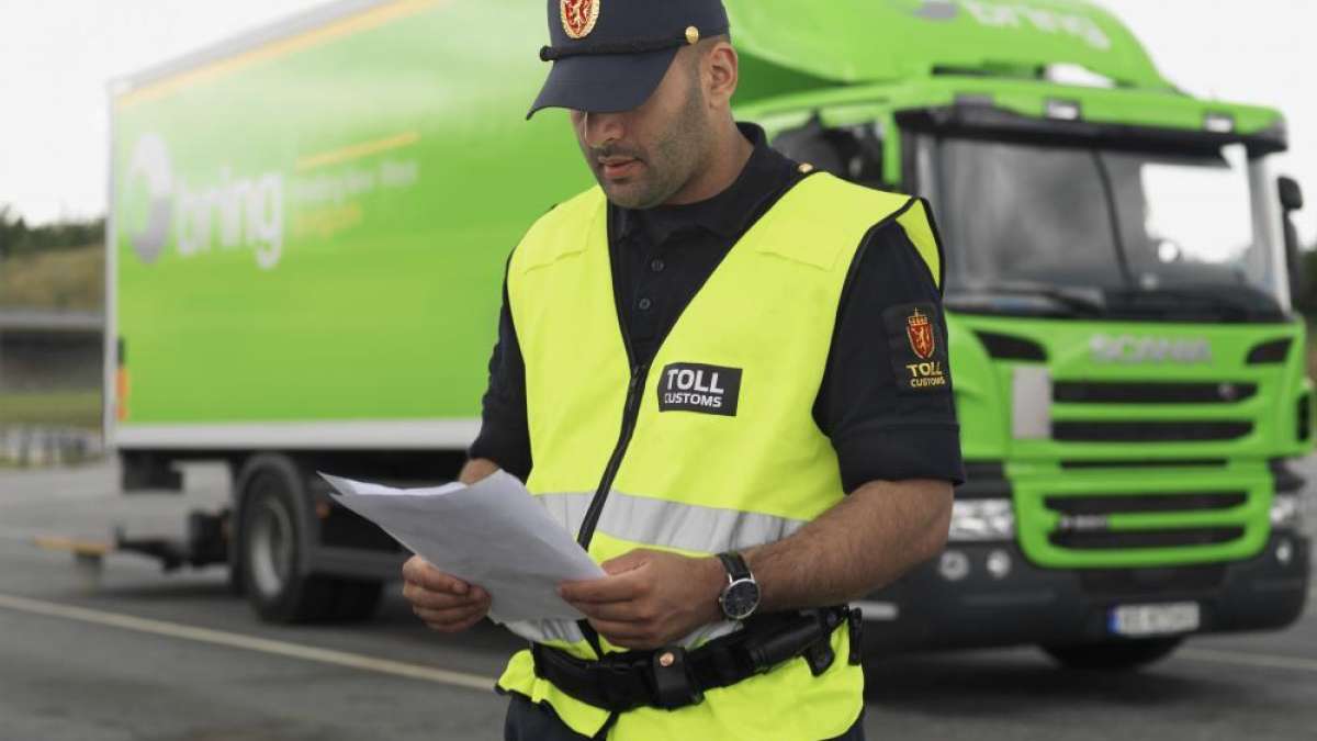 A customs officer is reading documents